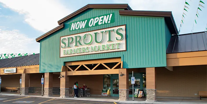 storefront with now open sign above door